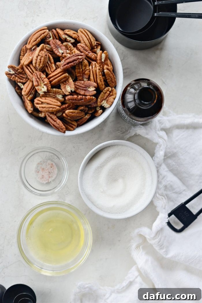 A flat lay of candied pecan ingredients: a bowl of pecans, granulated sugar, vanilla extract, an egg, and a salt shaker