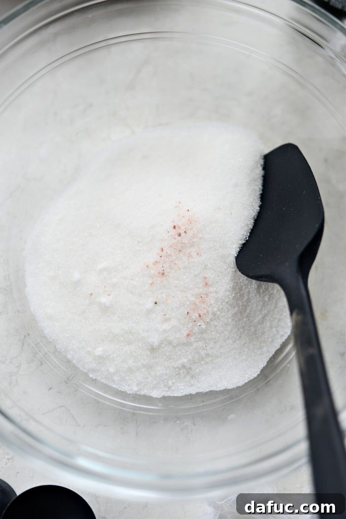 A small bowl containing granulated sugar and a pinch of fine salt, perfectly mixed