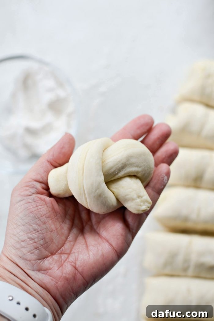 Multiple dough knots shaped and ready for baking