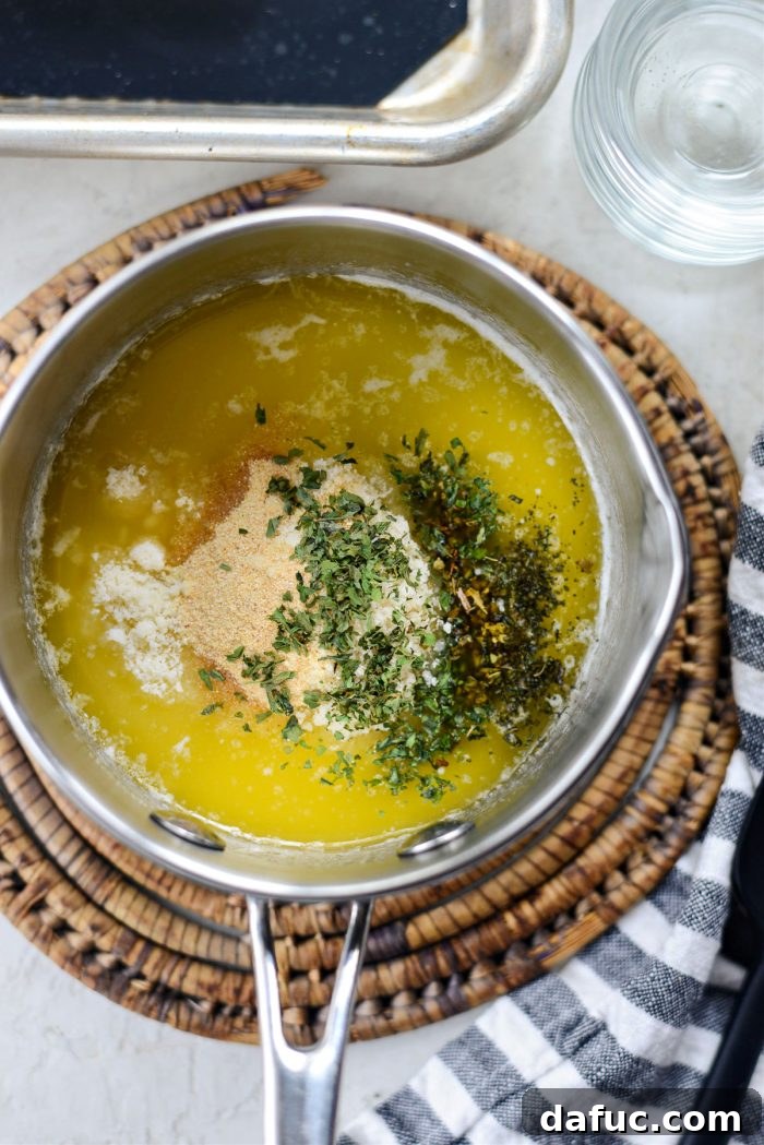 Melted butter combined with Parmesan cheese, garlic powder, and dried herbs
