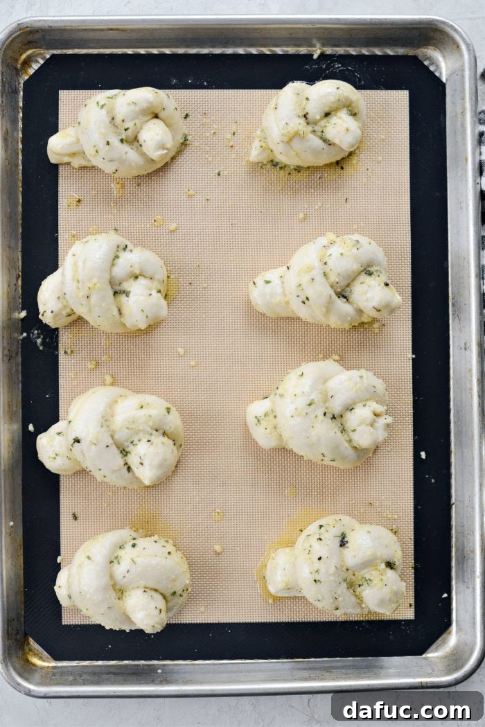 Garlic herb knots baking in the oven, turning golden brown