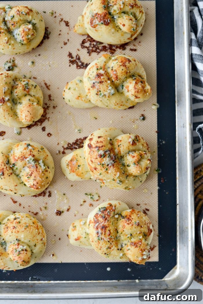 Close-up of baked Easy Homemade Garlic Herb Knots with a golden crust