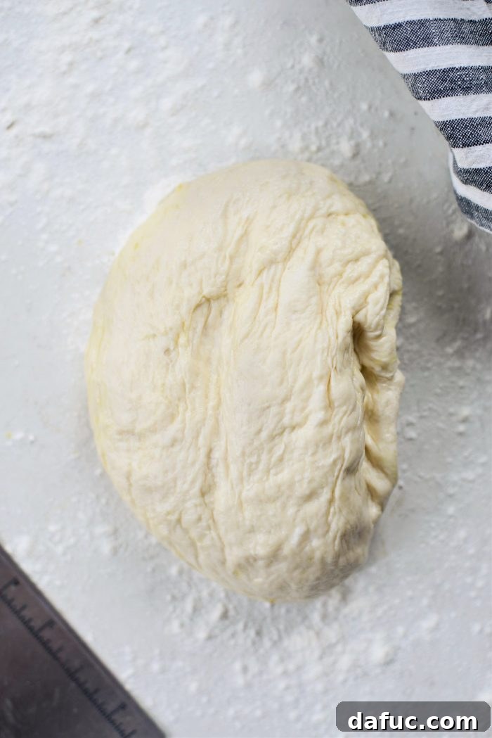 Turning pizza dough out onto a lightly floured surface