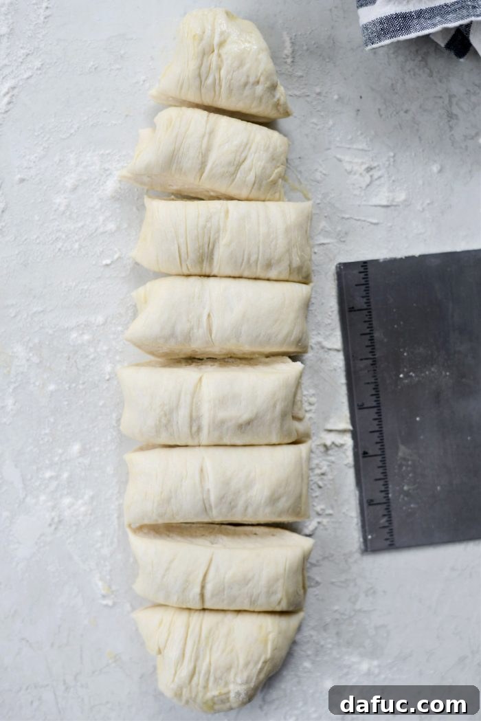 Cutting the dough log into 8 equal pieces