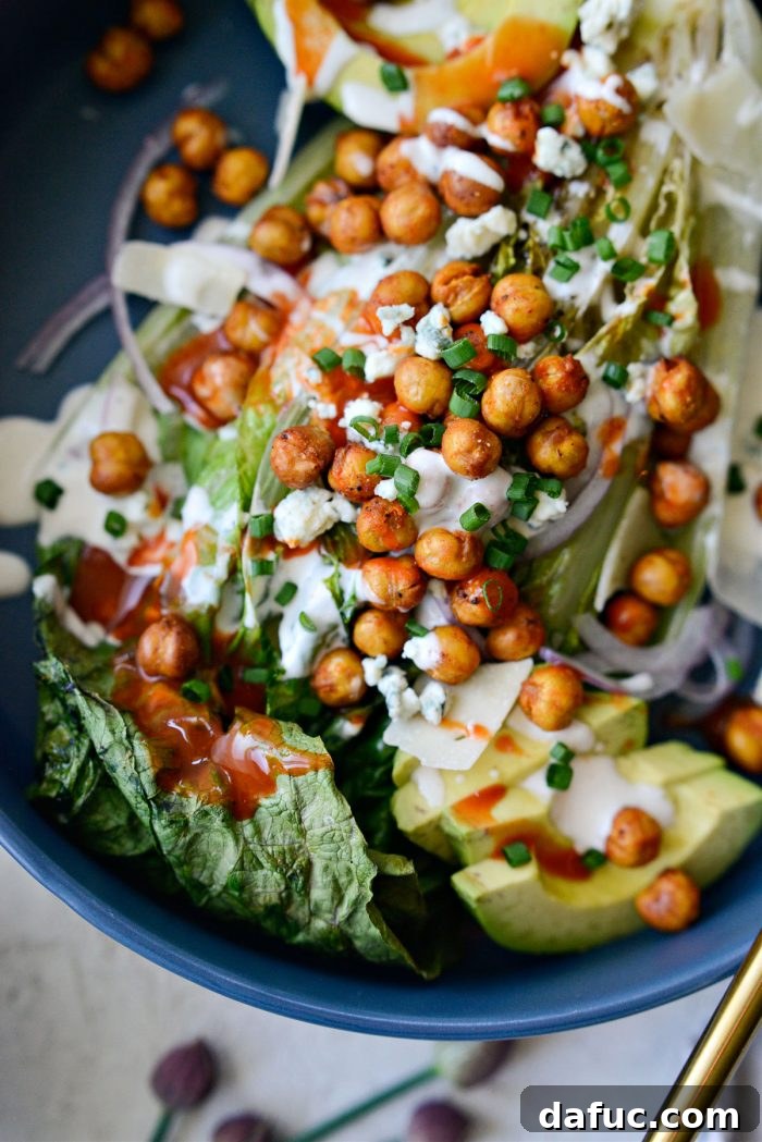 Air Fryer Buffalo Chickpea Caesar Salad - A close-up of the salad with chives on top.