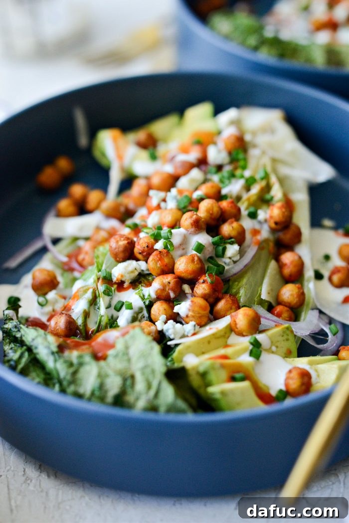 Air Fryer Buffalo Chickpea Caesar Salad - A vibrant, close-up image showcasing the texture and toppings of the salad.