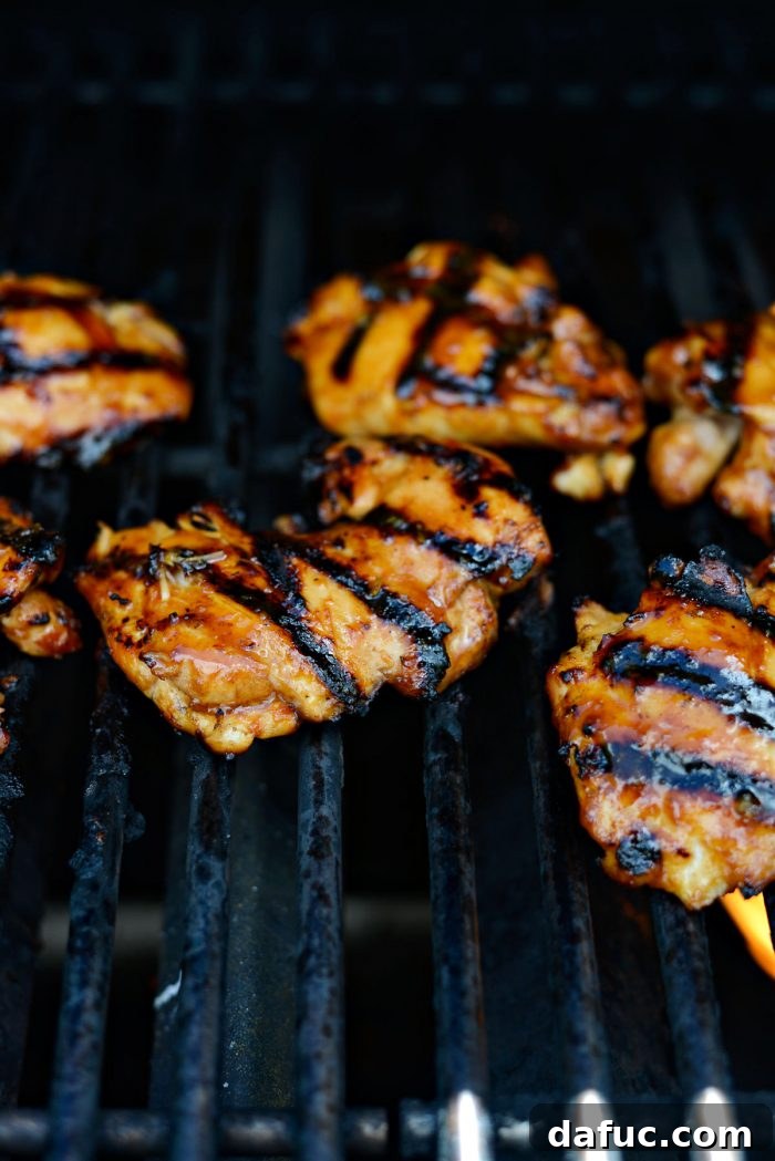 Huli Huli chicken turning on the grill, getting coated in a rich, caramelized glaze