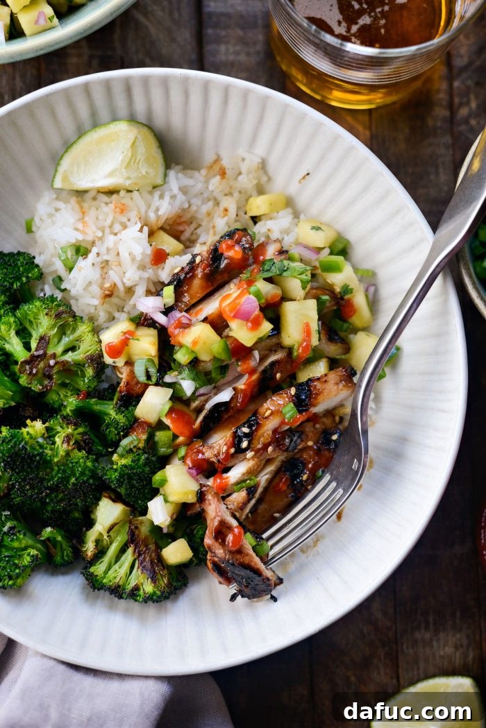 Huli Huli Chicken Rice Bowls with a squeeze of sriracha on top for extra spice