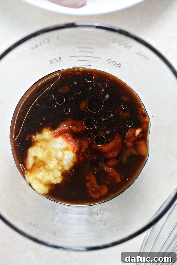 Various marinade ingredients neatly arranged in a bowl, ready to be whisked