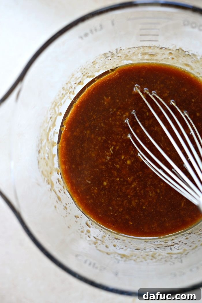 Whisked Huli Huli marinade ingredients in a bowl, showcasing the rich color and smooth texture