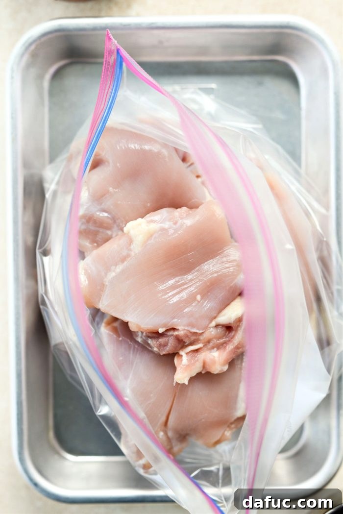 Boneless, skinless chicken thighs placed inside a resealable bag, ready for marination