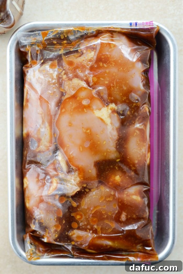 Chicken thighs marinating in the Huli Huli sauce inside a resealable bag in the refrigerator