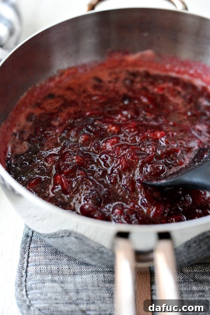 mashed cranberries in a saucepan, showcasing a chunky texture