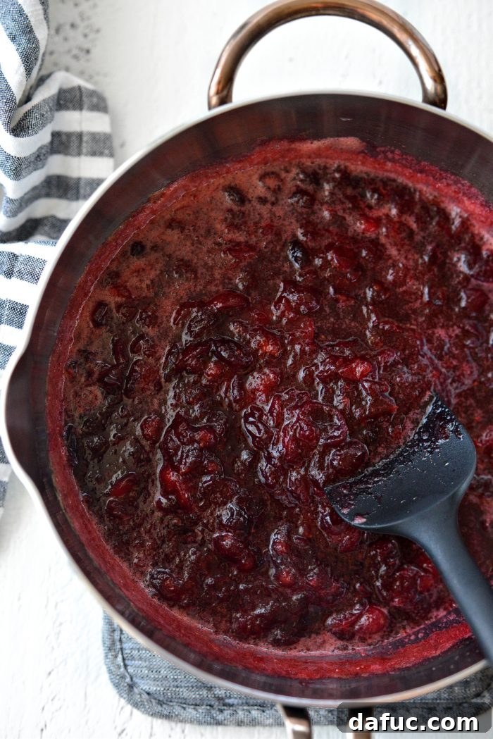 saucepan filled with freshly made homemade cranberry sauce, showcasing its rich color