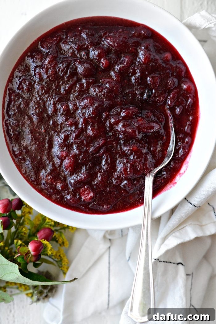 perfectly set homemade cranberry sauce in a white bowl, ready to be served