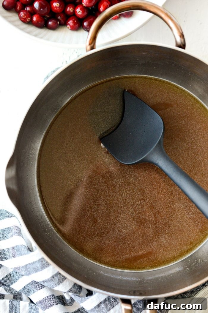 sugars fully dissolved into the orange juice and water in the saucepan