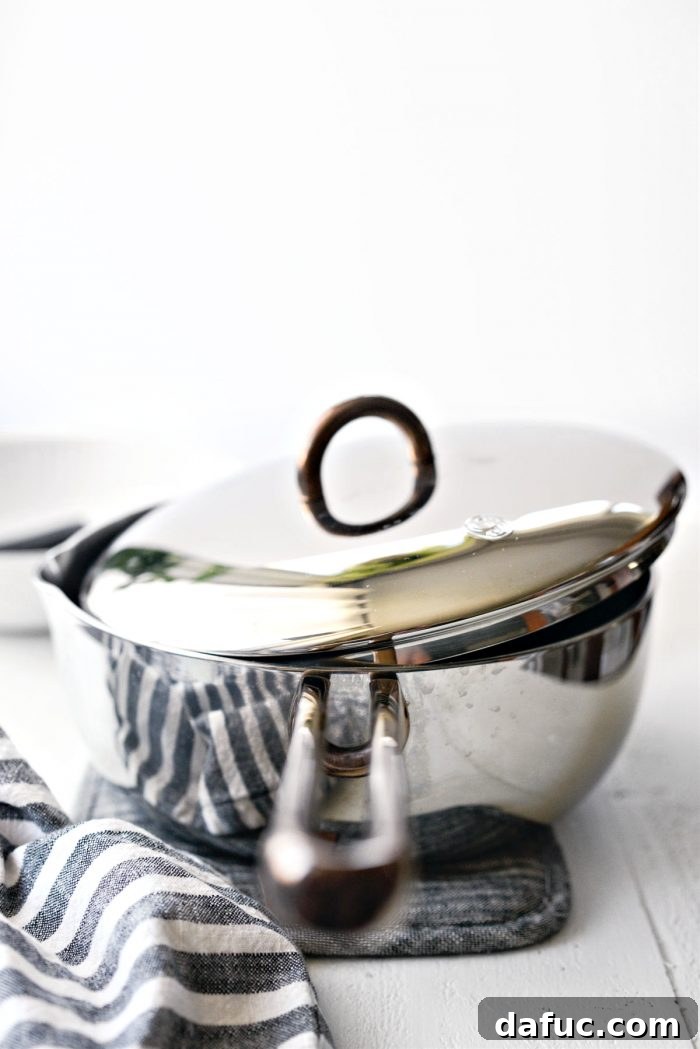 saucepan with the lid askew, allowing cranberries to simmer