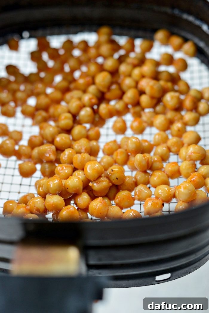 Buffalo chickpeas being air-fried in the air fryer basket