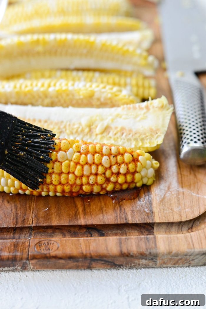 Brushing seasoned oil onto the corn wedges