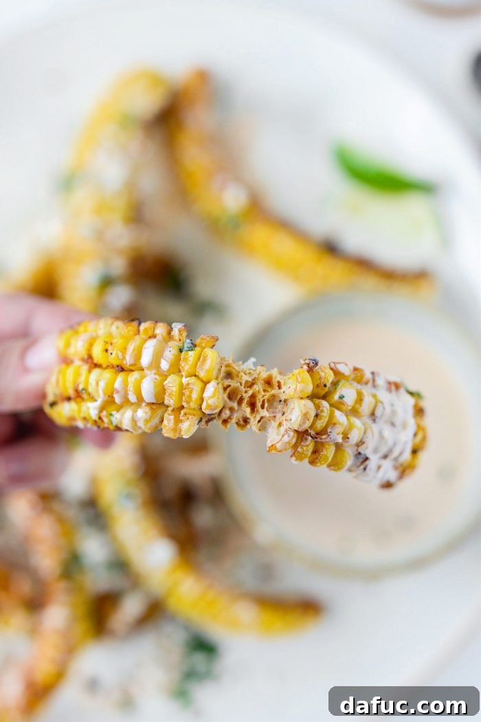 Close-up of a half-eaten Air Fryer Corn Rib, showing its juicy kernels