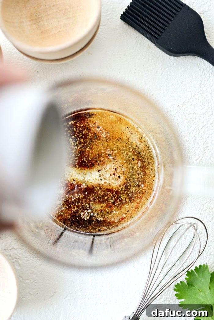 Olive oil being poured into the bowl of spices
