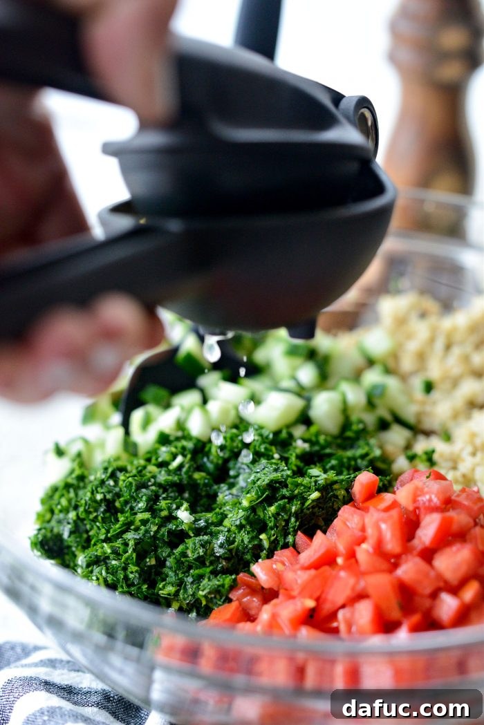 Golden Roasted Cauliflower Tabbouleh 11 Squeezing fresh lemon juice into the tabbouleh mixture