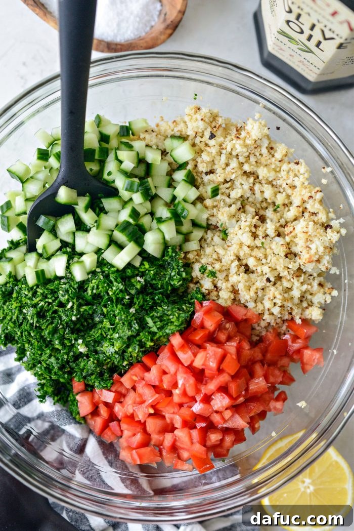 Golden Roasted Cauliflower Tabbouleh 10 Roasted cauliflower rice, herb mixture, diced tomato, and cucumber in a mixing bowl