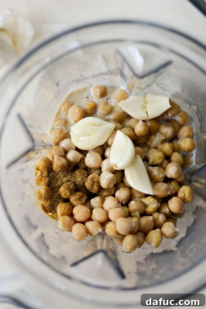 Velvet Smooth Blender Hummus 10 Garlic cloves and ground cumin ready to be added to the blender