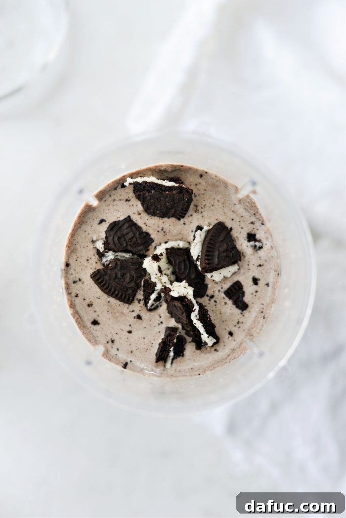 Espresso Cookies and Cream Milkshake 11 Extra crushed chocolate sandwich cookies being stirred into the blended milkshake.