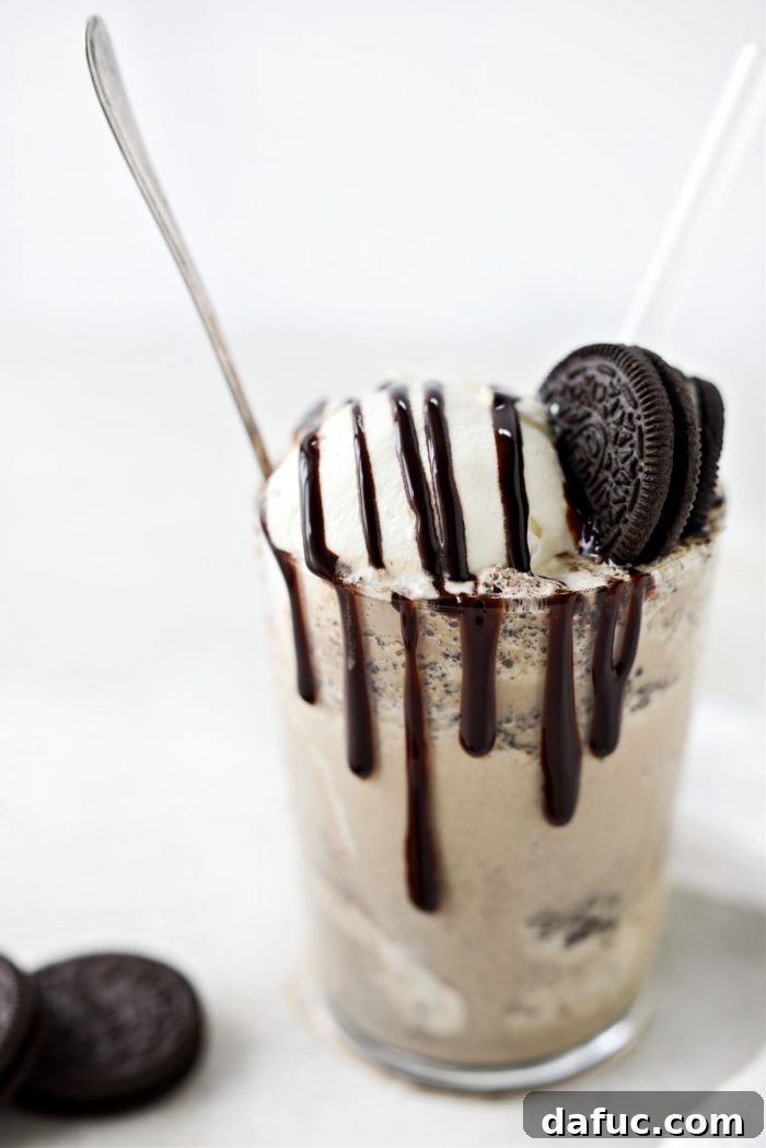 Espresso Cookies and Cream Milkshake 13 Beautifully garnished Espresso Cookies and Cream Milkshake with whipped cream, chocolate drizzle, and cookie crumbles, on a stylish wooden surface.