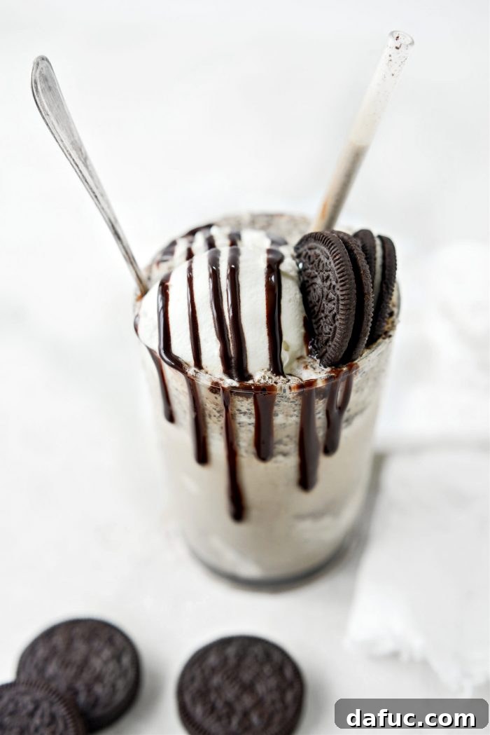 Espresso Cookies and Cream Milkshake 15 Close-up of the top of an Espresso Cookies and Cream Milkshake with whipped cream and chocolate cookie crumbles, showing its inviting texture.