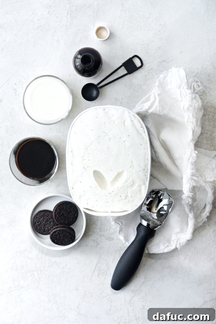 Espresso Cookies and Cream Milkshake 4 Ingredients for Espresso Cookies and Cream Milkshake laid out on a table, including chocolate sandwich cookies, a shot of espresso, milk, vanilla extract, and vanilla ice cream.