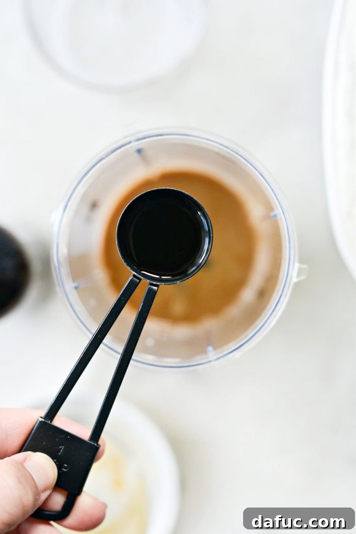 Espresso Cookies and Cream Milkshake 8 Three-quarters of a teaspoon of vanilla extract in a measuring spoon.