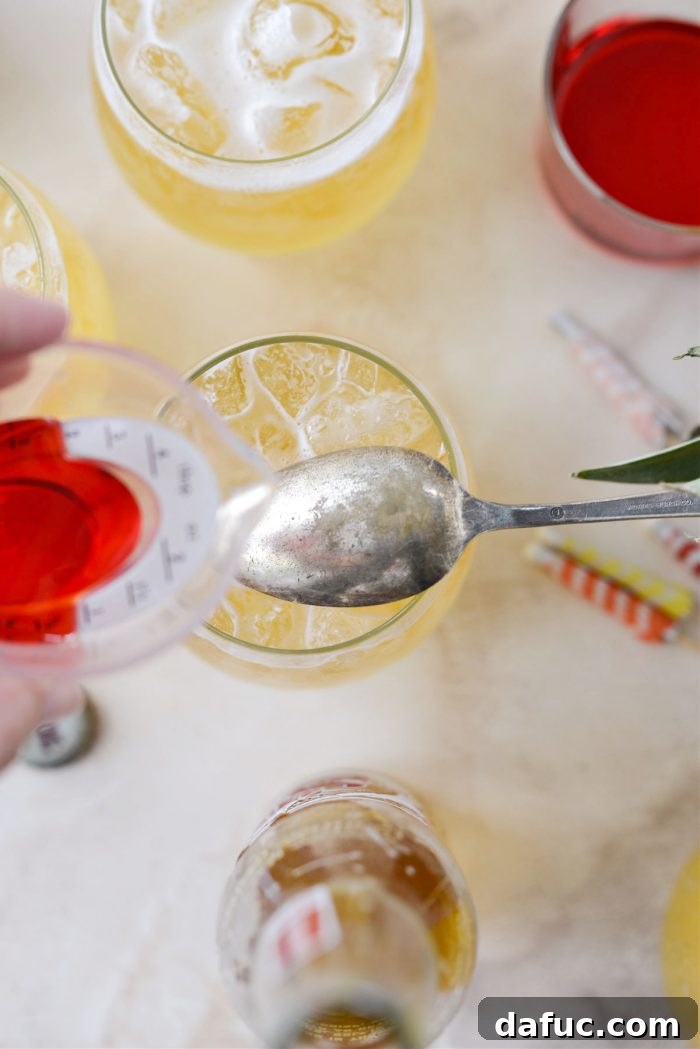 Tropical Tequila Sunrise Shandy 12 Placing an upside-down spoon over the glass to pour grenadine slowly