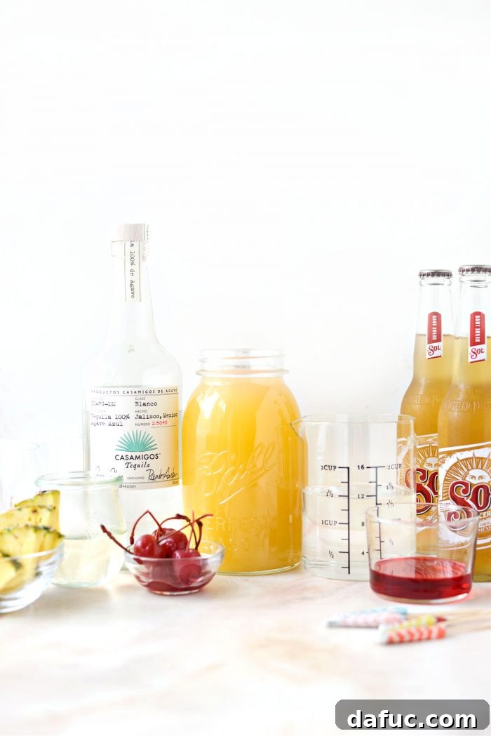 Tropical Tequila Sunrise Shandy 4 Ingredients for Pineapple Tequila Sunrise Shandy laid out on a table