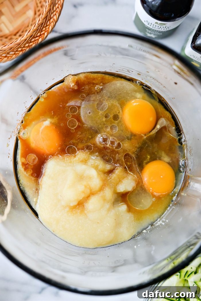 Wet ingredients added to the lemon sugar: eggs, olive oil, applesauce, lemon juice, vanilla extract, and lemon extract