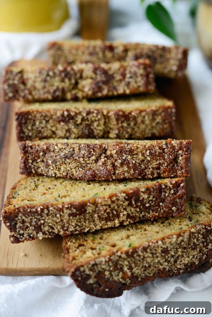 Whole loaf of golden-brown Lemon Poppy Seed Zucchini Bread on a cooling rack
