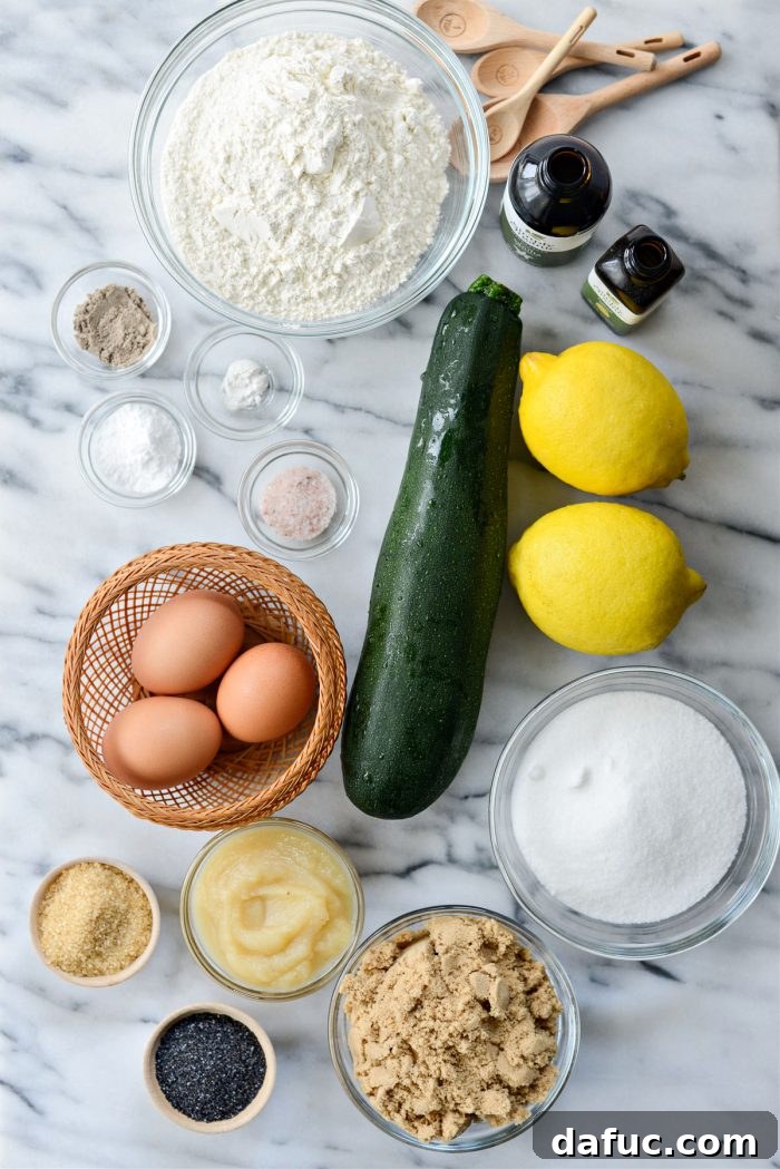 Array of fresh ingredients for Lemon Poppy Seed Zucchini Bread: flour, sugar, lemons, zucchini, eggs, oil, extracts, and poppy seeds