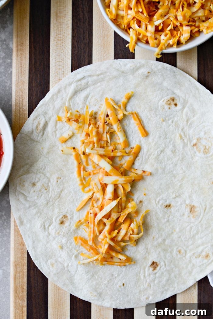 Crispy Hash Brown Morning Burritos 12 Add shredded cheese to the warmed tortilla.