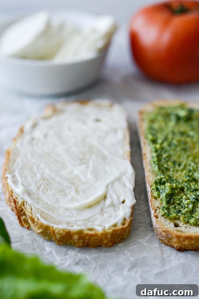 Spreading mayonnaise or mashed avocado on the other side of the bread
