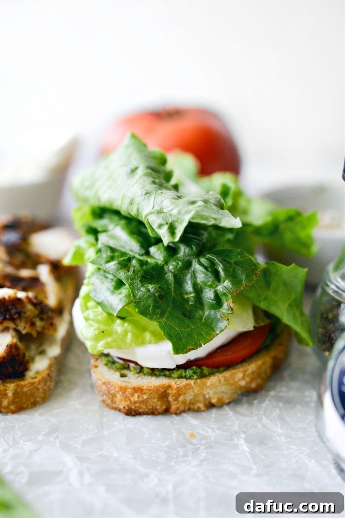 Adding crisp romaine lettuce to the sandwich