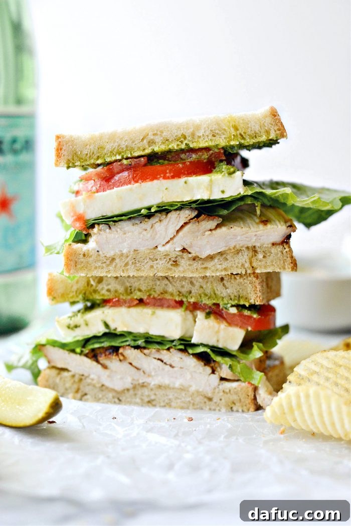 Close-up of the layered Grilled Turkey Pesto Sandwich with fresh ingredients