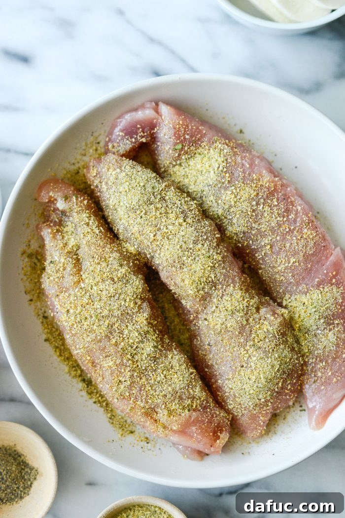 Seasoning turkey tenderloins with adobo and black pepper