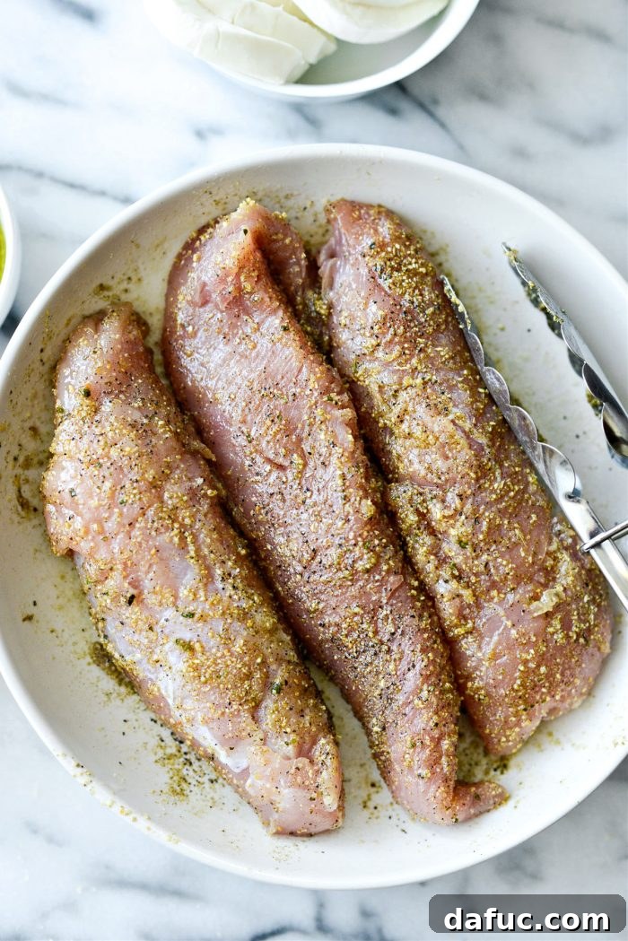 Tossing turkey tenderloins to ensure even seasoning