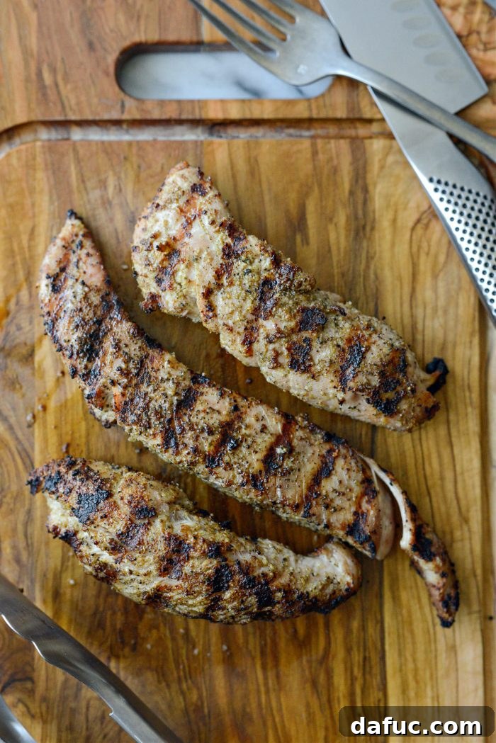 Resting grilled turkey tenderloins on a cutting board