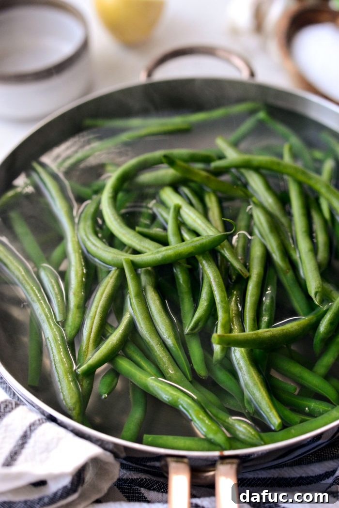 fresh green beans added to boiling water.