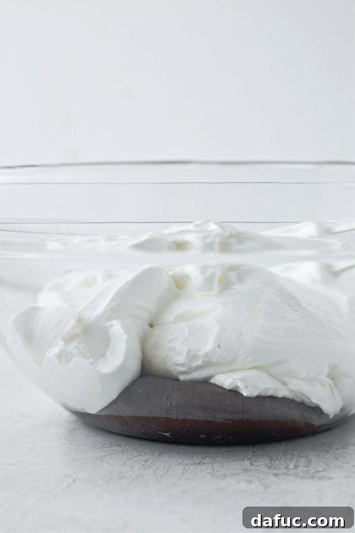 Blissful No-Churn Hash Indulgence 12 Adding whipped cream to the chocolate mixture in a large bowl