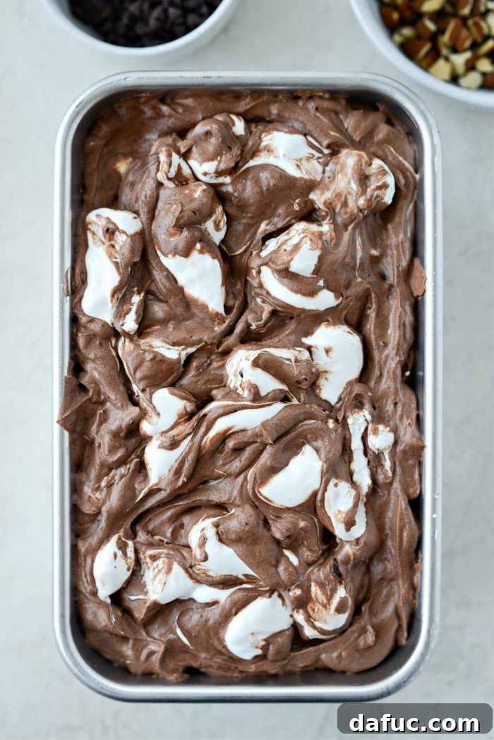 Blissful No-Churn Hash Indulgence 19 Transferring ice cream to a container and topping with more marshmallow creme