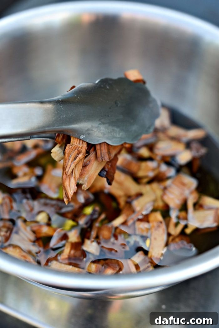 Irresistible Smoked Chile Queso 18 wood chips in tongs