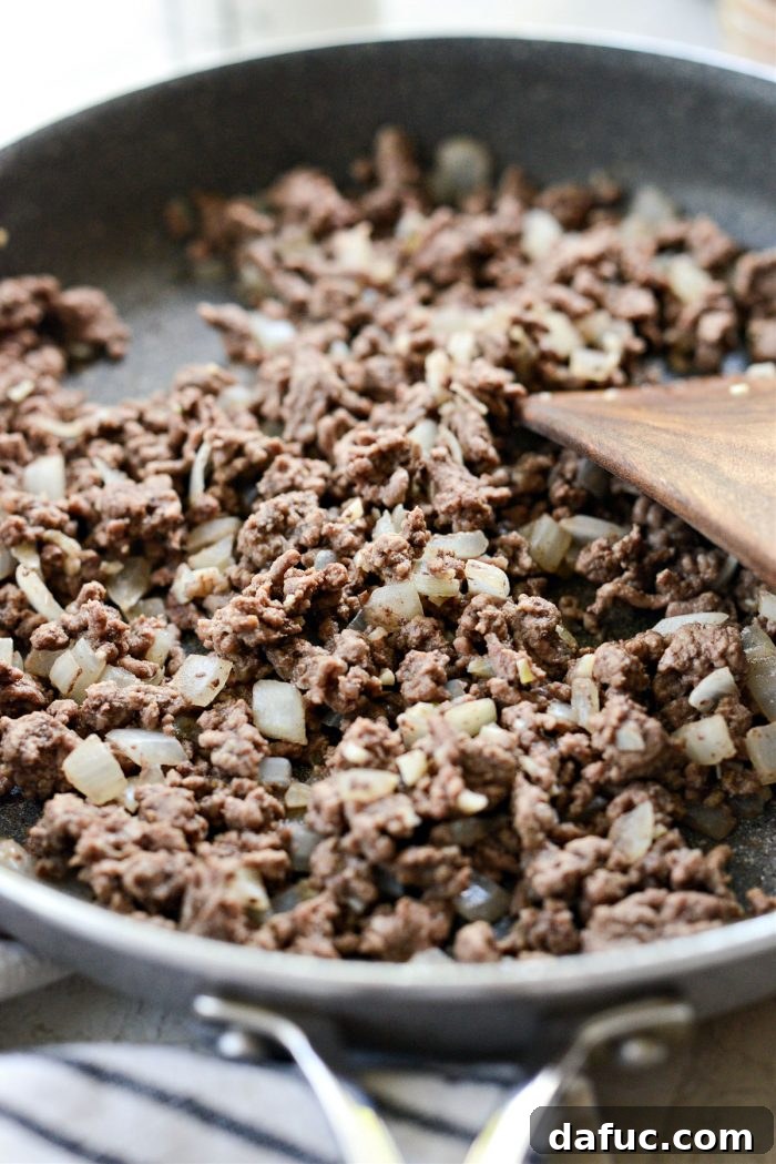 Irresistible Smoked Chile Queso 7 cooked ground beef, onions and garlic